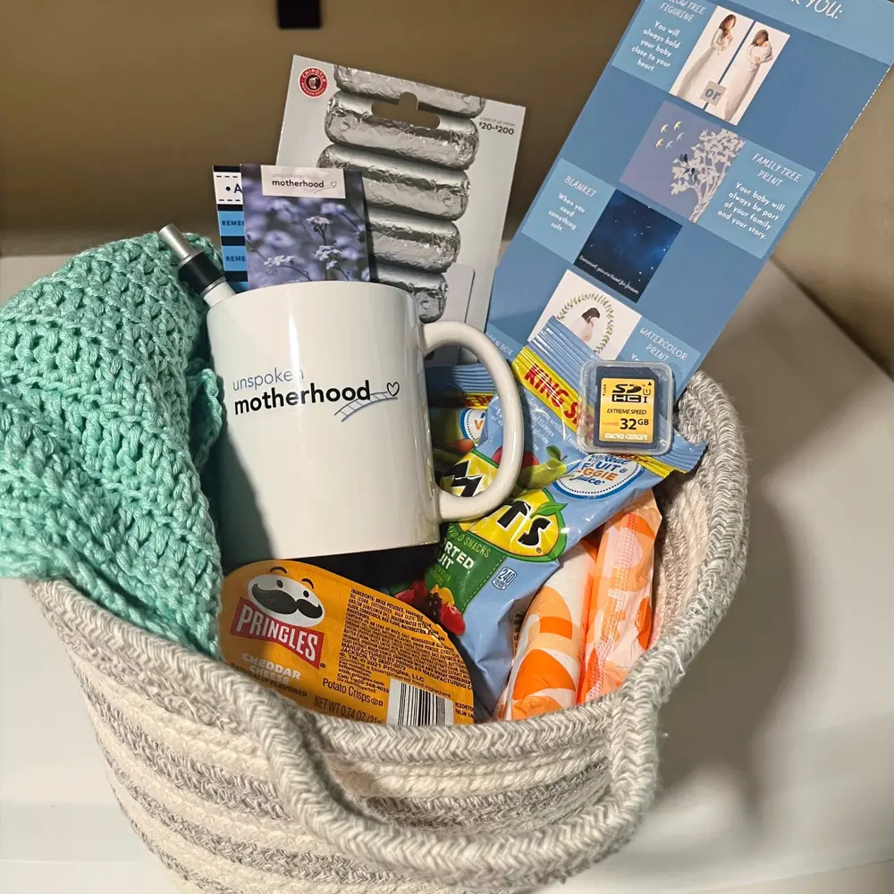 An Unspoken Motherhood remembrance basket with comfort items and resources